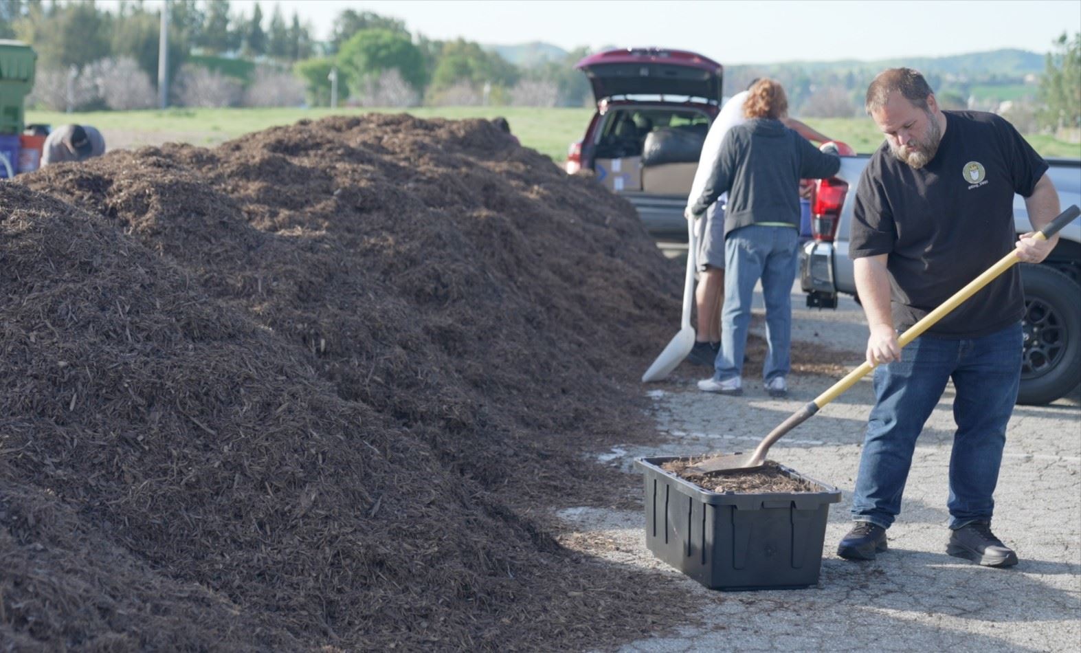 Photo of man shoveling mulch